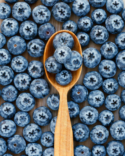 Fresh blue berries in a wooden spoon