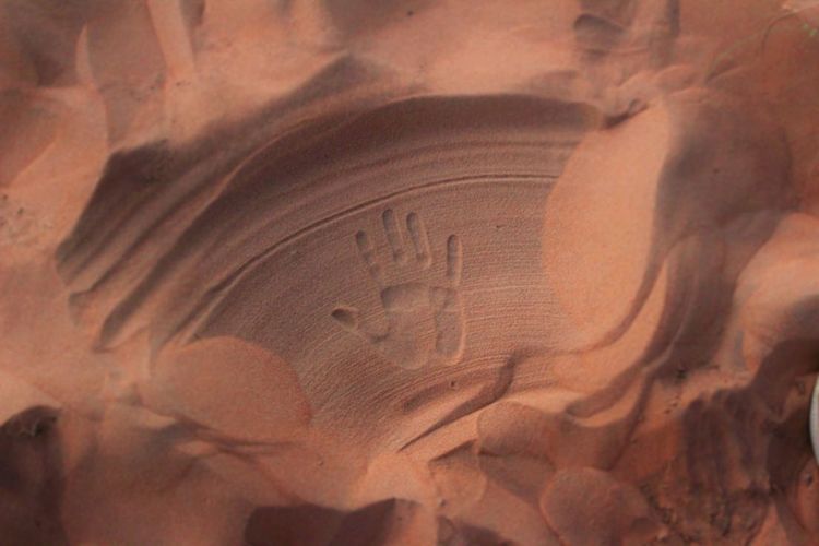 High angle view of handprint on sand