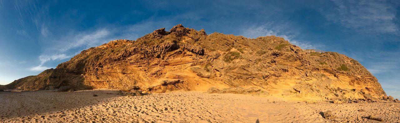 Rock formations on landscape against sky