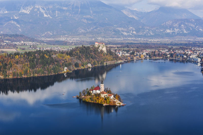 High angle view of lake by mountain against sky