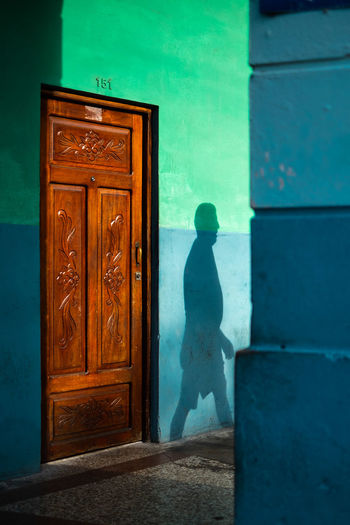 Wood - Material Door Entrance Architecture One Person Green Color Passing By Trough The Window Street Street Photography Streetphotography Street Light Shadow Contrast Fujifilm A New Beginning A New Perspective On Life Capture Tomorrow My Best Photo 17.62°