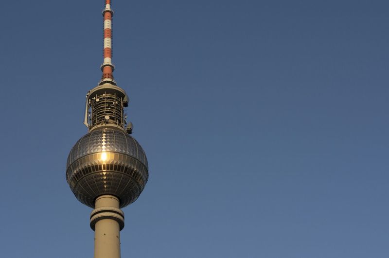 Low angle view of fernsehturm tower against clear sky