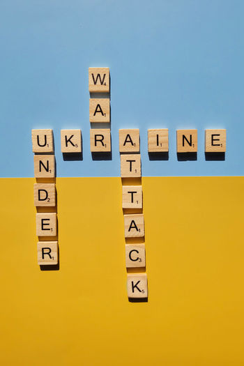 A lot of yellow stickers with words on blue background. concept of  support. stop war in ukraine
