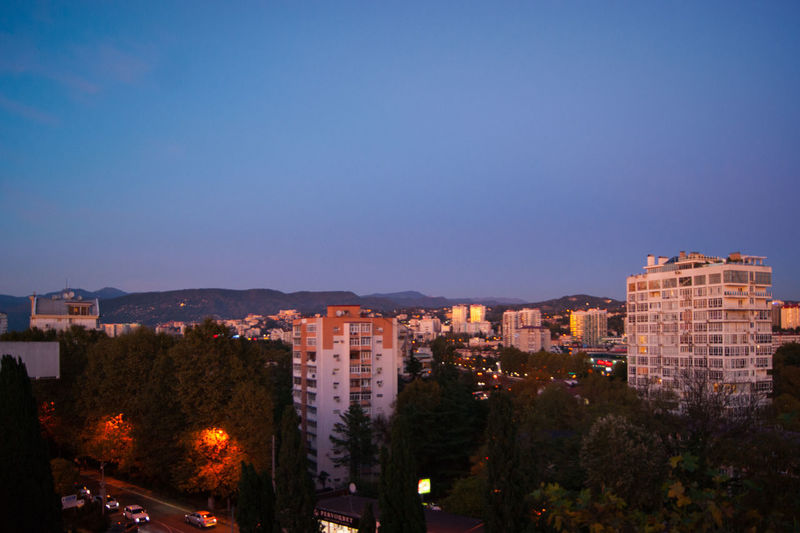 High angle view of illuminated buildings against sky at dusk