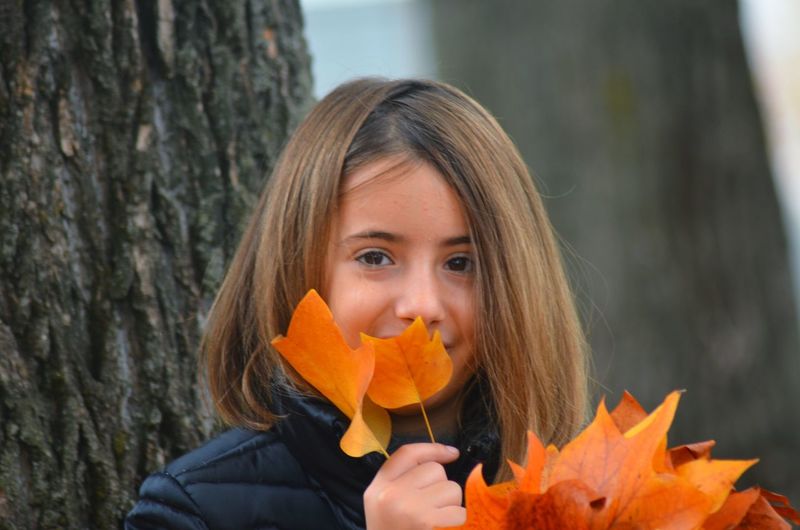 Portrait of girl smiling with tree