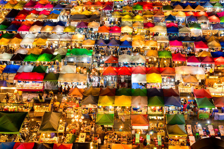Full frame shot of illuminated multi colored market stalls at night