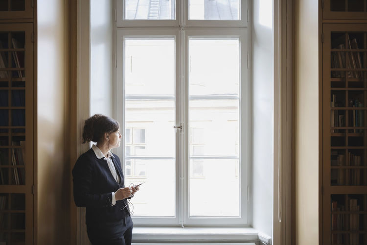 Woman standing by window