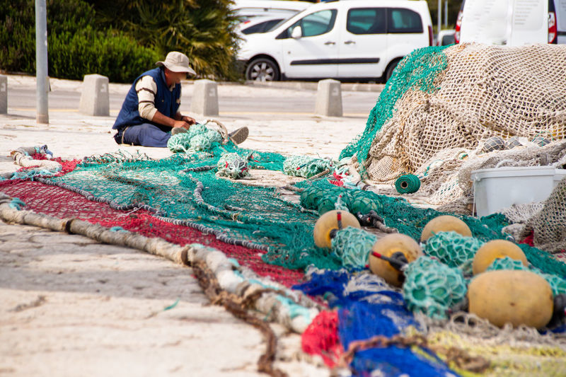 Man working with fishing net on land