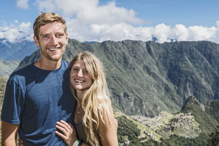 Portrait of smiling man and woman at mountains