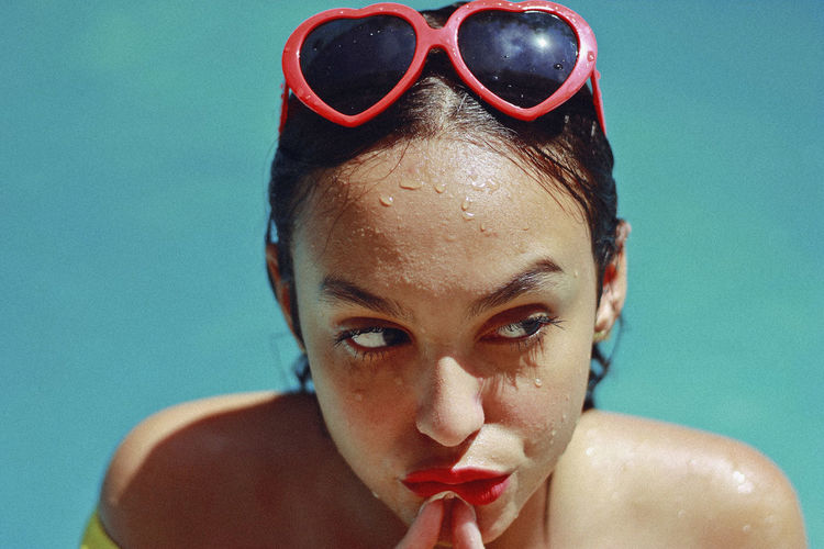 Close-up of thoughtful teenage girl in swimming pool