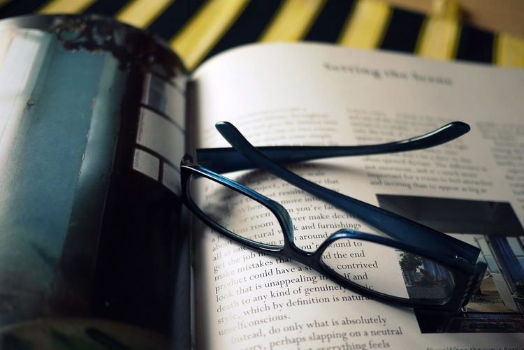 Close-up of glasses and book