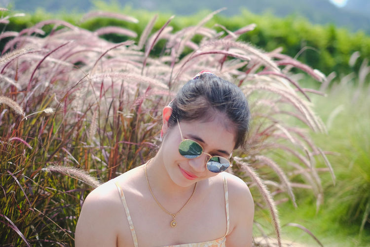 Portrait of young woman wearing sunglasses outdoors