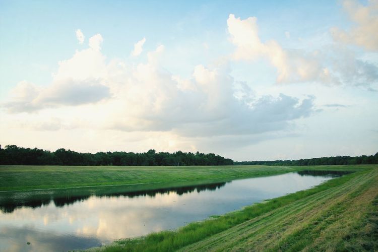 Scenic view of lake against cloudy sky