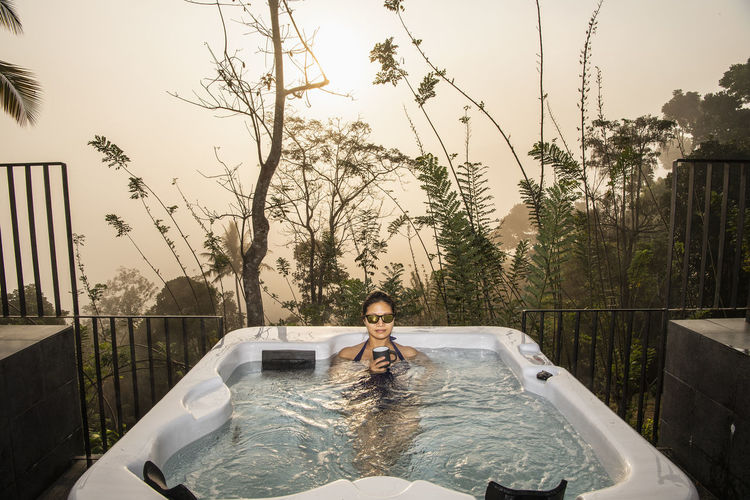 Woman enjoying a bath in a hot tub in the sri lankan highlands