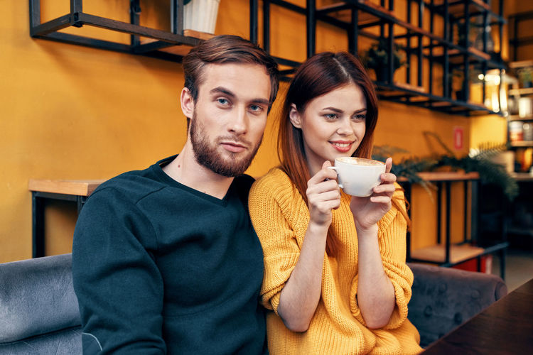 Young couple sitting at cafe