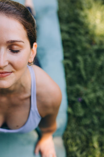 High angle view of woman smiling doing yoga