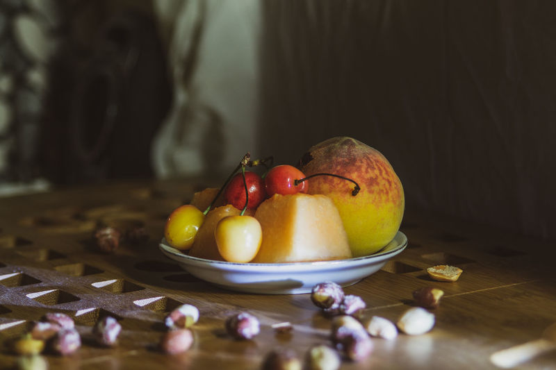Close-up of fruits in plate on table at home