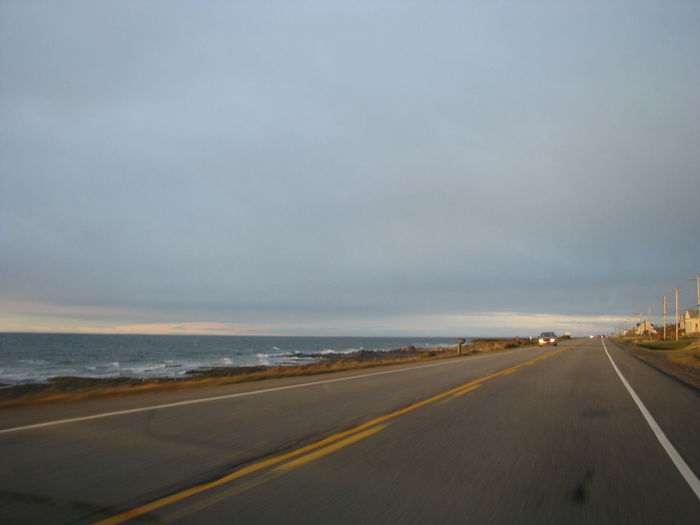 Road by sea against sky
