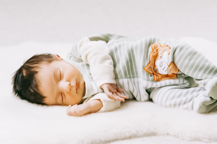 Cute baby lying on bed at home