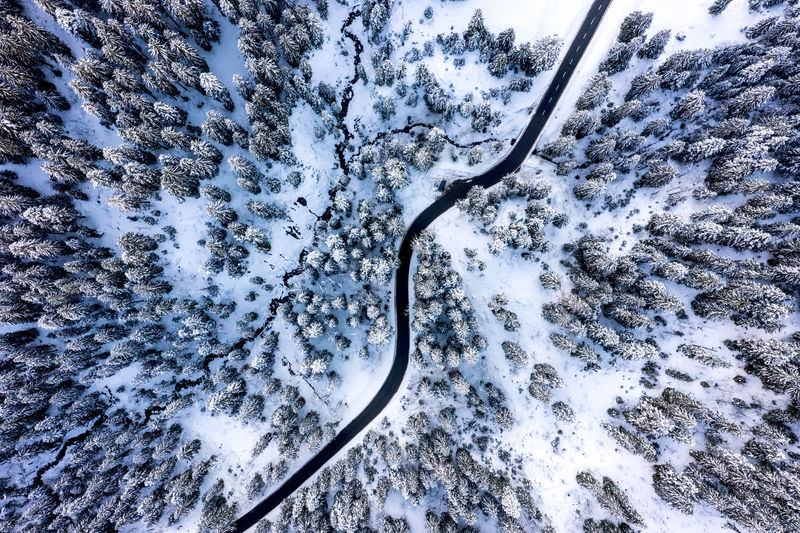 High angle view of road through snow covered land