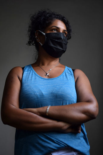 Interior portrait of woman wearing a face mask