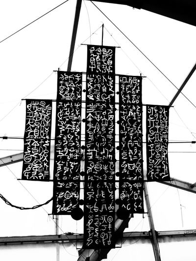 Low angle view of lanterns hanging by building against sky