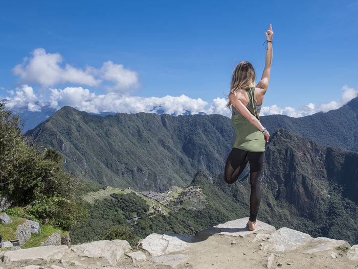 Woman practising yoga on the inca trail close to machu picchu