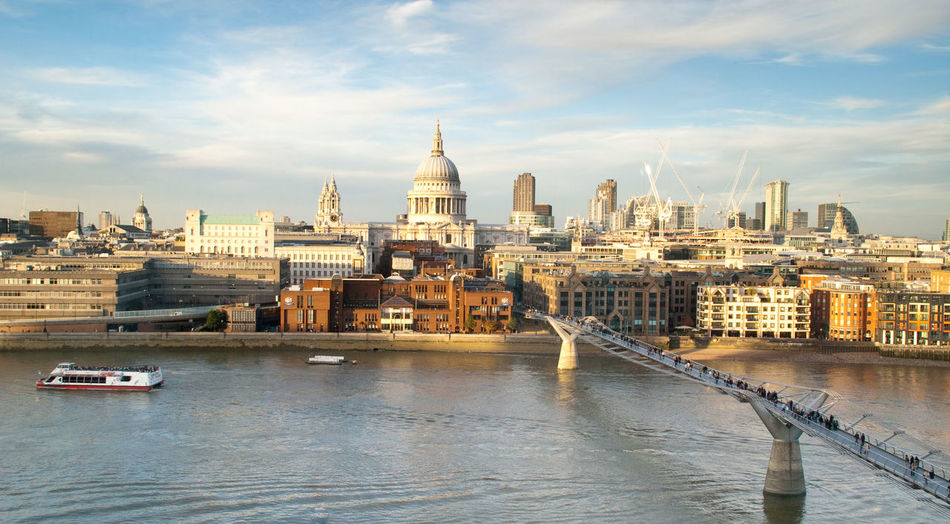 St paul cathedral in front of river against sky