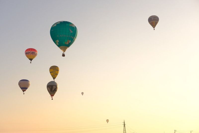 Hot air balloons against clear sky during sunset