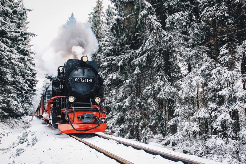 Steam train on railroad track during winter