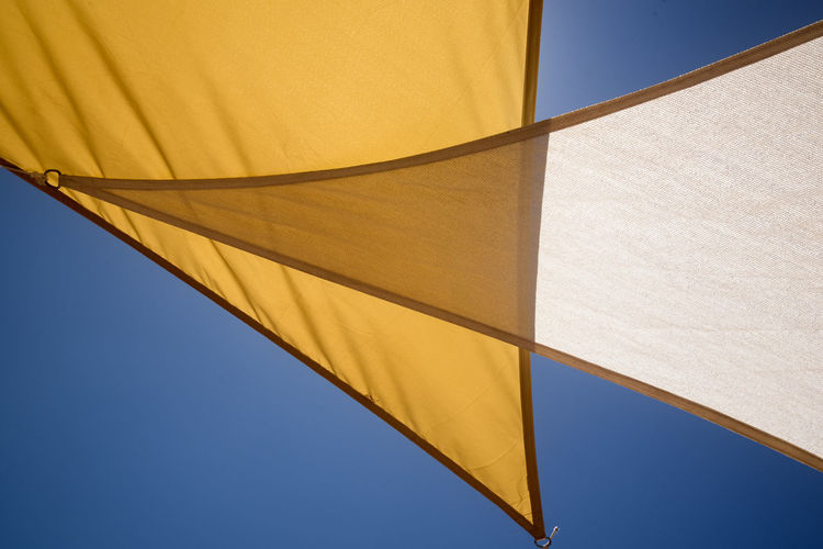 Low angle view of yellow flag against clear sky
