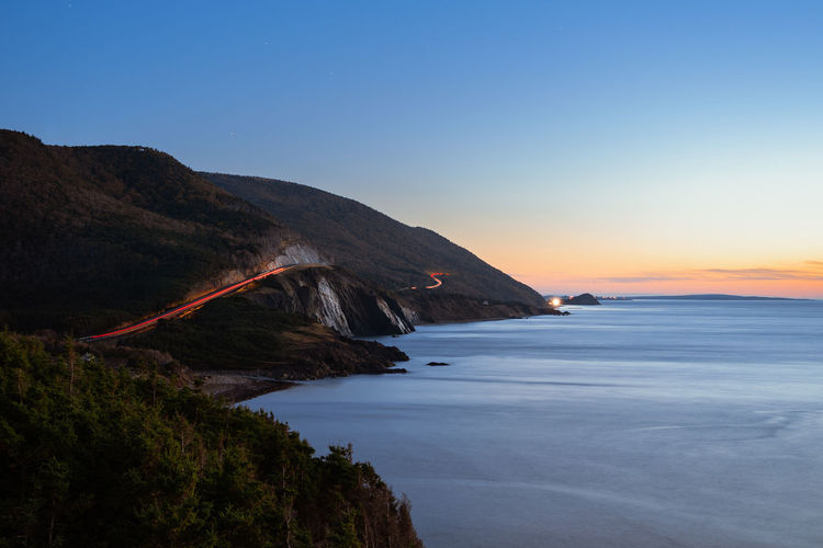 Scenic view of sea against sky during sunset along the cabot trail of nova scotia, canada