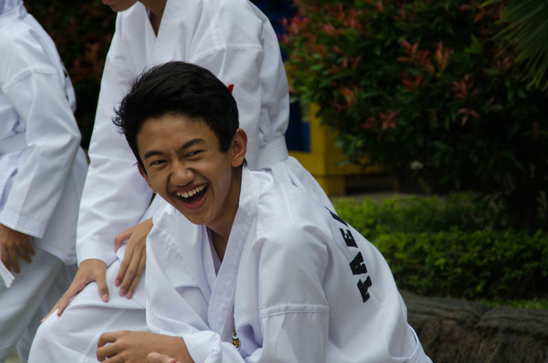 Portrait of teenage boy laughing outdoors