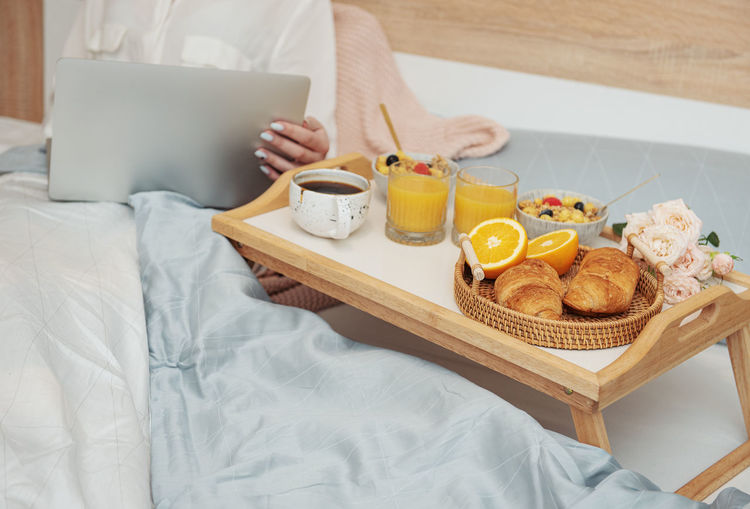 Romantic breakfast with coffee, waffles, orange juice and rose flowers.