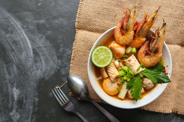 Tom yam soup originating from thailand. tom yum is made with shrimp, chili, lime, chicken, fish, 