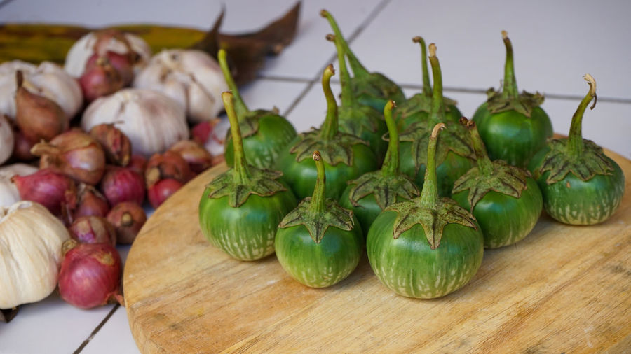 Close up green eggplants on a cutting board