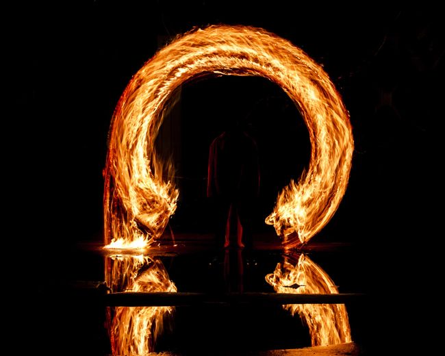 Reflection of illuminated ferris wheel at night