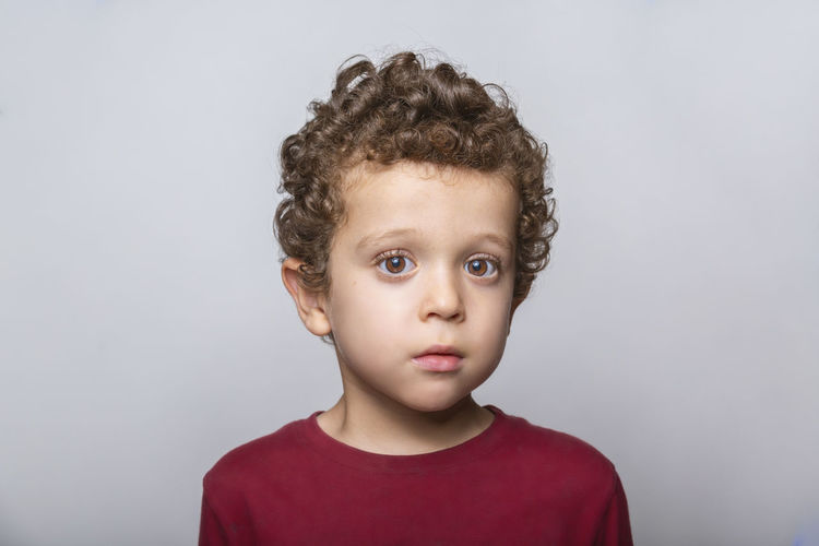 Close-up of a beautiful caucasian boy with curly hair