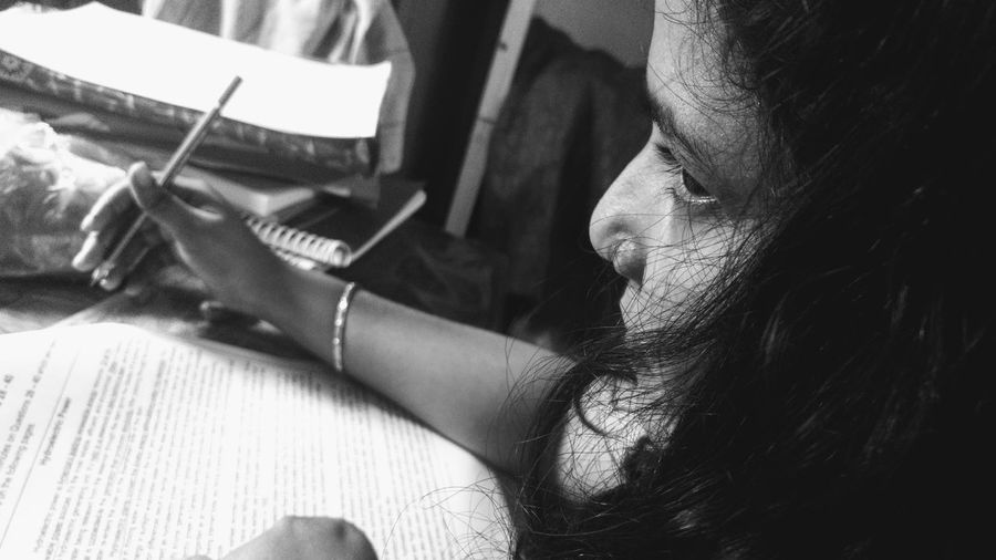 Close-up portrait of woman sitting at home