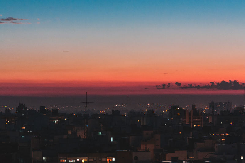 High angle view of illuminated buildings against sky during sunset