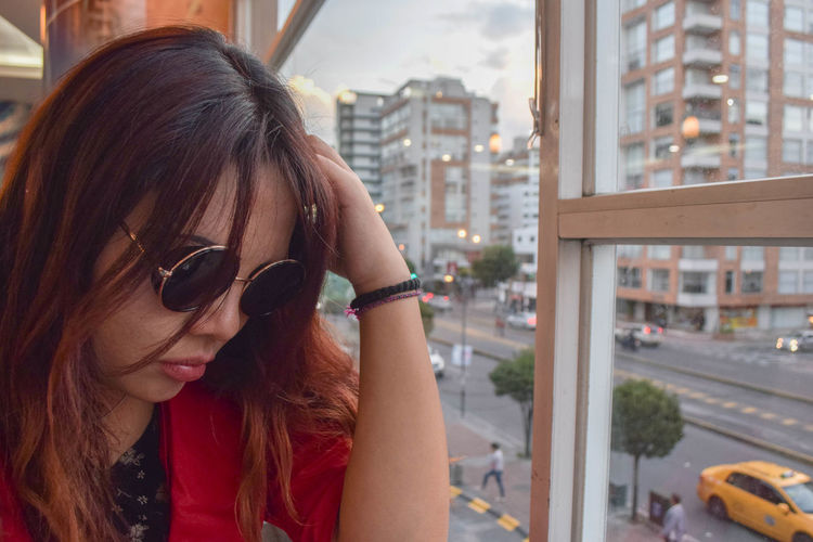 Portrait of young woman in city