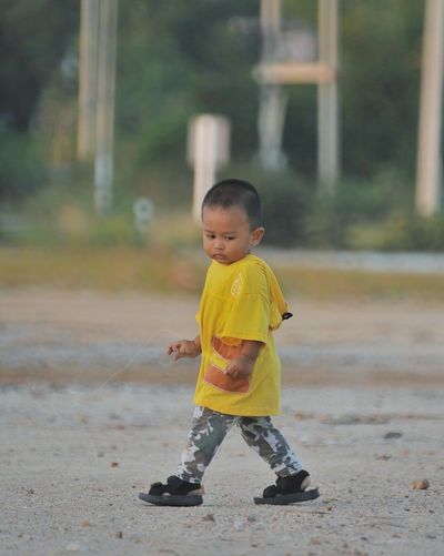 Full length of a boy running on land