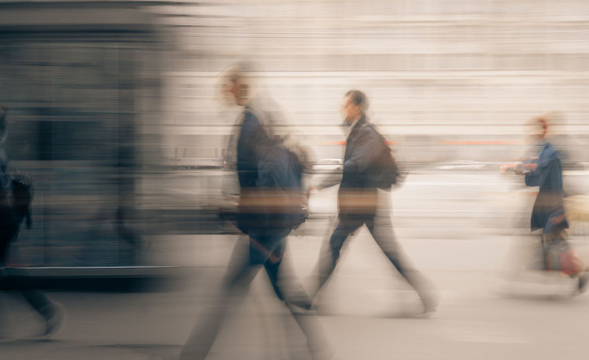 Blurred motion of people walking in city