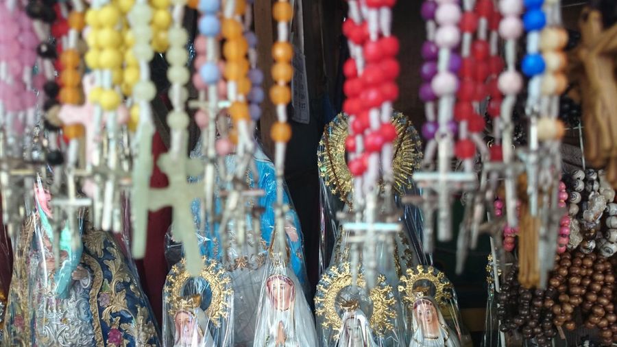 Rosary beads hanging at market for sale