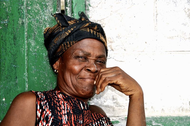 Portrait of smiling woman against wall