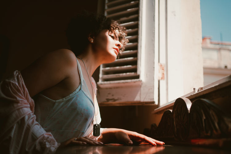side view of young woman working on table
