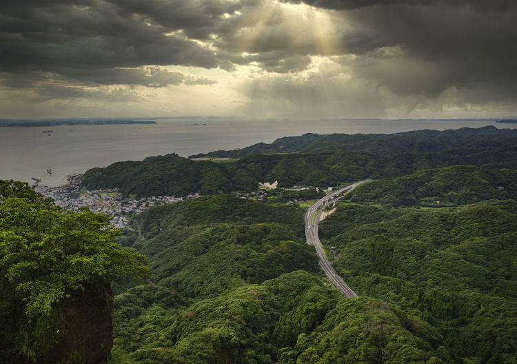 Sunlight filtering through a cloudy sky on the uraga channel and the futtsu-tateyama road.