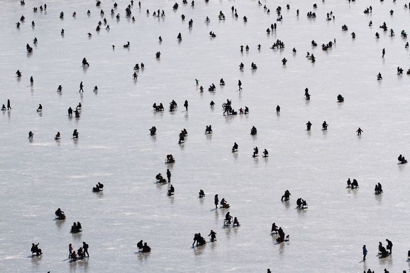 High angle view of people on frozen lake