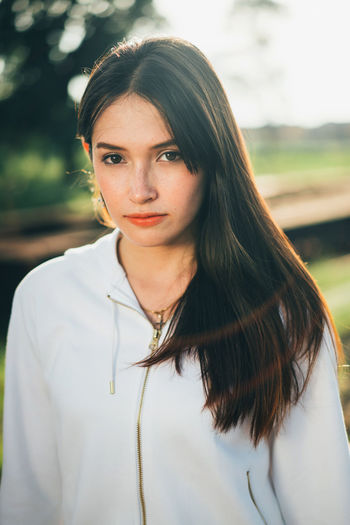 Portrait of young woman standing outdoors