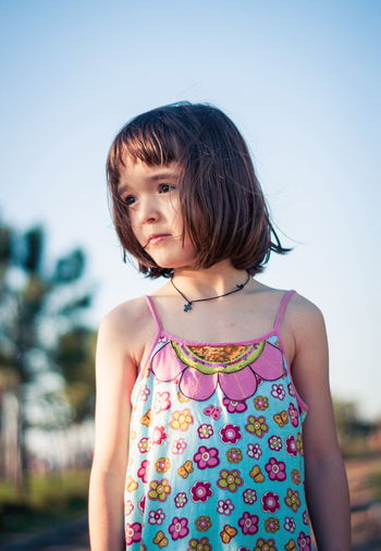 Little girl having fun outdoors in sunset